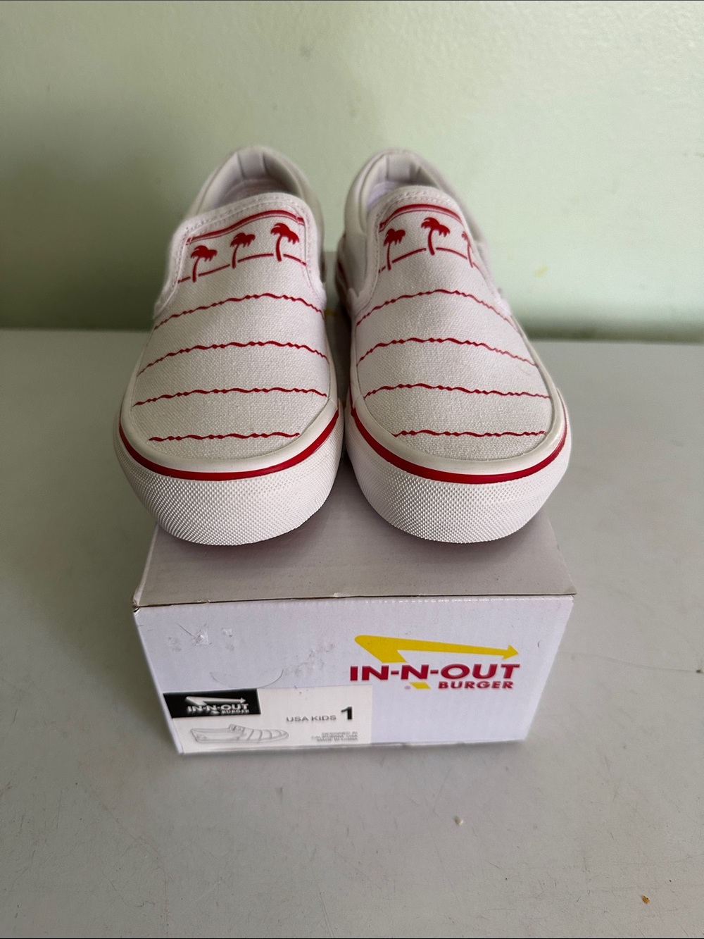 Vans Kids Slip-On Sneakers in White and Red with Palm Tree Detail